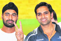 Gurpreet Singh (L) and Omkar Singh after winning the men's 10m Air Pistol (Pairs) shooting competition at the Commonwealth Games in New Delhi on Thursday