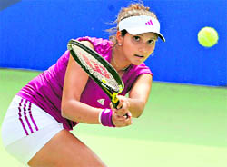 Sania Mirza returns a shot against Olivia Rogowska of Australia during their women's singles group match