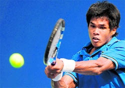 Somdev Devvarman returns a shot against Amresh Jayawickreme of Sri Lanka during men's singles match