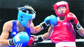 India's Suranjoy Mayengbam (red) and Malaysian pugilist Mohd Subriein in action during the 52-kg category boxing event in New Delhi on Saturday. Suranjoy won the bout.