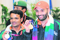 Gold medalist Harpreet Singh (R) and silver medalist Vijay Kumar of India pose with their medals.