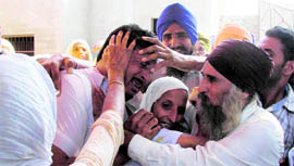 A member of the family of Pirthi Pal Singh is consoled in Chak Ali Sher village in Mansa district on Tuesday.