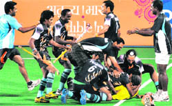 Indian hockey players celebrate after their victory against England in the men's semi-final field hockey match.