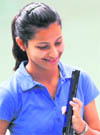 Heena Sidhu watches her pistol. She won silver in 10 meter air pistol event