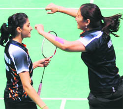 Gold medallists Jwala Gutta (right) and Ashwini P Machimanda celebrate after winning doubles badminton match in New Delhi on Thursday.