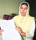 Foster sister of Balwant Singh with a copy of the letter written by her brother regarding pledging of his eyes.
