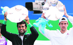 Jurgen Melzer (R) of Austria with teammate Leander Paes of India as they hold their trophies after winning the doubles final against Mariusz Fyrstenberg and Marcin Matkowski of Poland