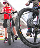 Ferrari Formula 1 driver Fernando Alonso poses for pictures on a bike at the Korea International Circuit in Yeongam
