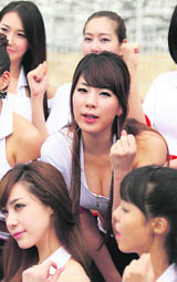 Grid girls pose in the paddock after the qualifying session of the South Korean F1 Grand Prix the Korea International Circuit in Yeongam on Saturday.