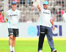 Indian captain MS Dhoni (R) and coach Gary Kirsten inspect the ground at the Jawaharlal Nehru cricket stadium in Margao on Sunday. 