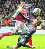 Arsenal's Theo Walcott puts the ball past Tim Krul in Newcastle,