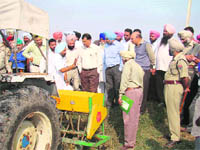District administration officials and farmers during the demonstration of Happy Seeder in Fatehgarh Sahib during the visit of Chief Secretary SC Aggarwal.