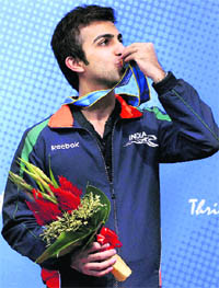 Pankaj Advani kisses his gold medal won during the men's billiards singles event at the 16th Asian Games in Guangzhou on Sunday