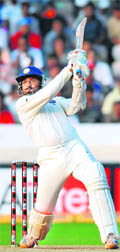 Harbhajan Singh hits a boundary during the third day of second Test against New Zealand in Hyderabad on Sunday