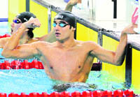 Indian swimmer Virdhawal Vikram Khade reacts after winning bronze in the men's 50m butterfly event of the 16th Asian Games in Guangzhou 