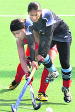 Indian captain Surinder Kaur vies for the ball with a Japanese player during their match at the 16th Asian Games in Guangzhou 