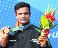 Vijay Kumar posing for a picture after winning bronze in men�s 25m centre fire pistol event at Aoti Shooting Range