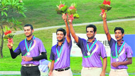 Rahul Bajaj, Rashid Khan, Abhinav Lohan and Abhijit Singh Chadha of India celebrate on the podium during the medals ceremony for the men's team golf event at the 16th Asian Games in Guangzhou on Saturday. South Korea won gold and Taiwan won bronze.