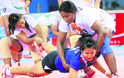 Thailand's Chonlada Chaiprapan is taken down by India's Sanahanbi Devi Kangabam, left, and Bai V Tejeswini on Friday. India won the match to take the gold medal. 