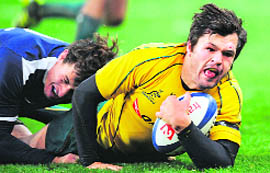 Australia's centre Adam Ashley Cooper (R) is tackled by France's Yannick Jauzion during the Rugby union test match between France and Australia in Paris on Sunday.