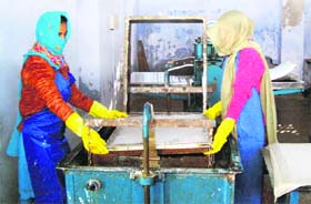 Two HIV+ widows work at a paper recycling unit in Anandpur Sahib