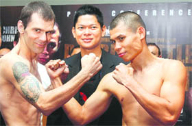 World Boxing Association (WBA) featherweight champion Chris John of Indonesia (R) and challenger Fernando Saucedo of Argentina (L) pose during the official weigh-in ahead of their title bout in Jakarta on Saturday.