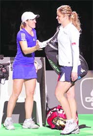 Justine Henin of Belgium and compatriot Kim Clijsters greet each other before their Diamond Games exhibition match in Antwerp on Thursday.
