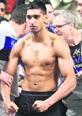 WBA super lightweight champion Amir Khan of Britain poses for fans during an official weigh-in at the Mandalay Bay Events Center in Las Vegas on Saturday.