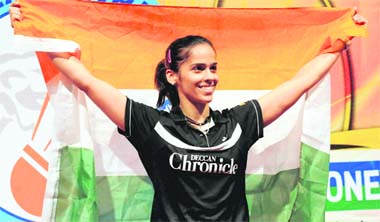 In this photo released by China's Xinhua news agency, Saina Nehwal celebrates with the Tricolour after winning the Hong Kong Open Super Series on Sunday. 