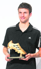 Thomas Mueller, Adidas Golden Boot Winner poses with his award during the FIFA Soccer World Cup award ceremony at the Adidas headquarters in Germany, on Tuesday.