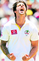 Mitchell Johnson celebrates after taking the wicket of England's Kevin Pietersen in Perth on Friday