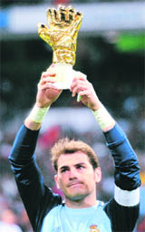 Real Madrid's goalkeeper Iker Casillas holds up his 2010 World Cup Golden Glove award at their Spanish first division match against Sevilla in Madrid