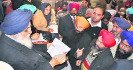 Punjab Chief Minister Parkash Singh Badal distributes cheques during sangat darshan programme in Bassi Pathana on Tuesday.