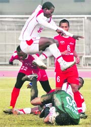 JCT and Air India players in action in Ludhiana on Saturday.
