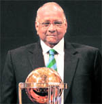 ICC president Sharad Pawar poses with the 2011 Cricket World Cup trophy during an event to mark its 30-day countdown in Mumbai on Wednesday