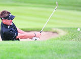 Ian Poulter of England hits out of the bunker at the 9th green during the second round of the Abu Dhabi Golf Championship at the Abu Dhabi Golf Club 