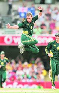 Australian fast bowler Brett Lee celebrates after taking a wicket in Brisbane on Sunday