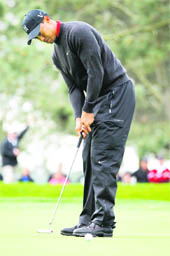 Tiger Woods putts on the first hole in the final round play on Torrey Pines in the Farmers Insurance Open PGA tournament in California on Sunday.