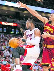 Miami Heat's Dwyane Wade (L) goes up to score against the Cleveland Cavaliers Joey Graham during fourth quarter of their game in Miami, Florida on Monday.