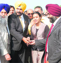 Navjot Sidhu (second from  left) and Pargat Singh (extreme right) hand over car keys to Mandeep Kaur in Amritsar on Saturday.