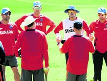 Indian cricketers listen to coach Gary Kirsten during a training session at the M.Chinnaswamy Stadium in Bangalore on Thursday. Captain Mahendra Singh Dhoni said his team is well-equipped to handle the pressure of playing in a World Cup in front of home crowds