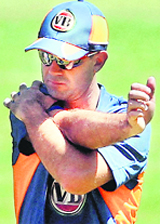 Australian Captain Ricky Ponting stretches during a training session ahead of the ICC World Cup 2011 at the Chinnaswamy stadium in Bangalore