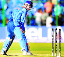 Virender Sehwag looks at the stumps after being bowled during a warm-up match against Australia at M.Chinnaswamy Stadium in Bangalore on Sunday