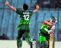 Tamim Iqbal (R) is bowled by Abdul Razzaq in Dhaka on Tuesday.