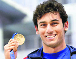Veer Dhawal Khade after winning the gold in the 50 m freestyle swimming event during the 34th National Games in Ranchi, on Tuesday.