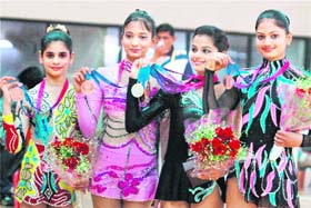 Members of Punjab's Rhythmic Gymnastic team pose for a photo after winning the bronze during the 34th National Games in Ranchi