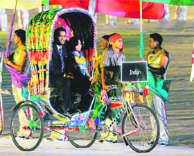 Mahendra Singh Dhoni arrives in a cycle rickshaw during the opening ceremony of the Cricket World Cup at Bangabandhu Stadium in Dhaka