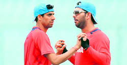 Ashish Nehra (L) and Yuvraj Singh warm-up during a training session at The Sher-e-Bangla National Stadium in Dhaka on Friday.