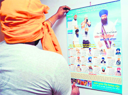 A person puts up a calendar mentioning death anniversaries of terrorists in his house in the Nabha road area in Patiala. 