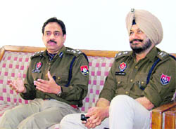 DIG (Ropar range) MF Farooqui (left) and SSP, Ropar, Jatinder Singh Aulakh, interacts with mediapersons in Ropar on Monday.